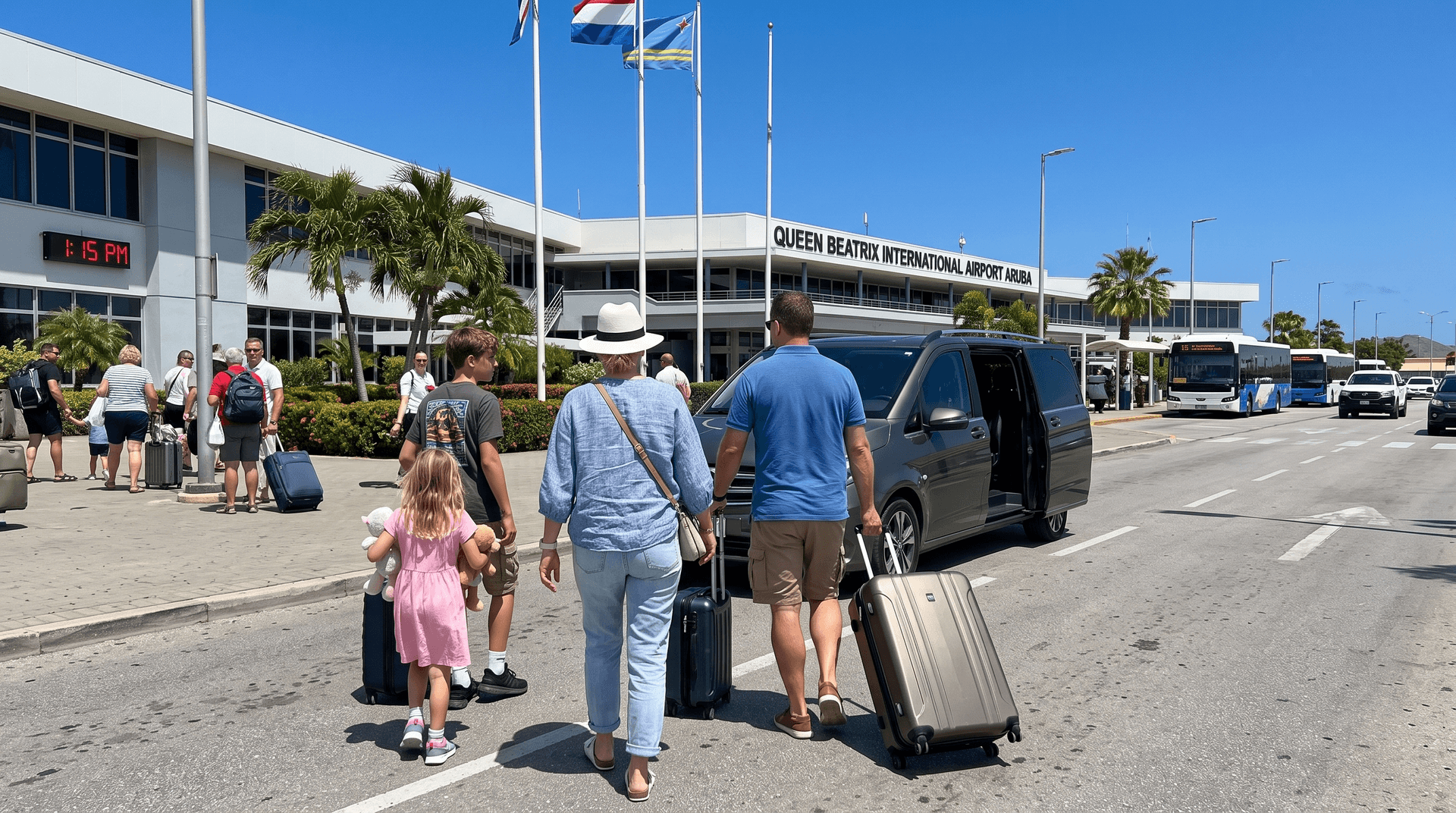 Family with suitcases walks toward a grey minivan outside Queen Beatrix International Airport in Aruba during high season