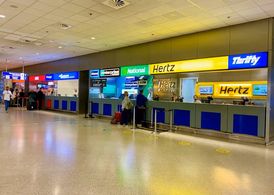 Rental car parked near the arrivals area at Queen Beatrix International Airport, Aruba