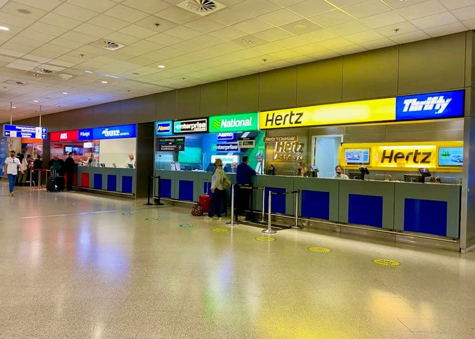 Rental car parked near the arrivals area at Queen Beatrix International Airport, Aruba