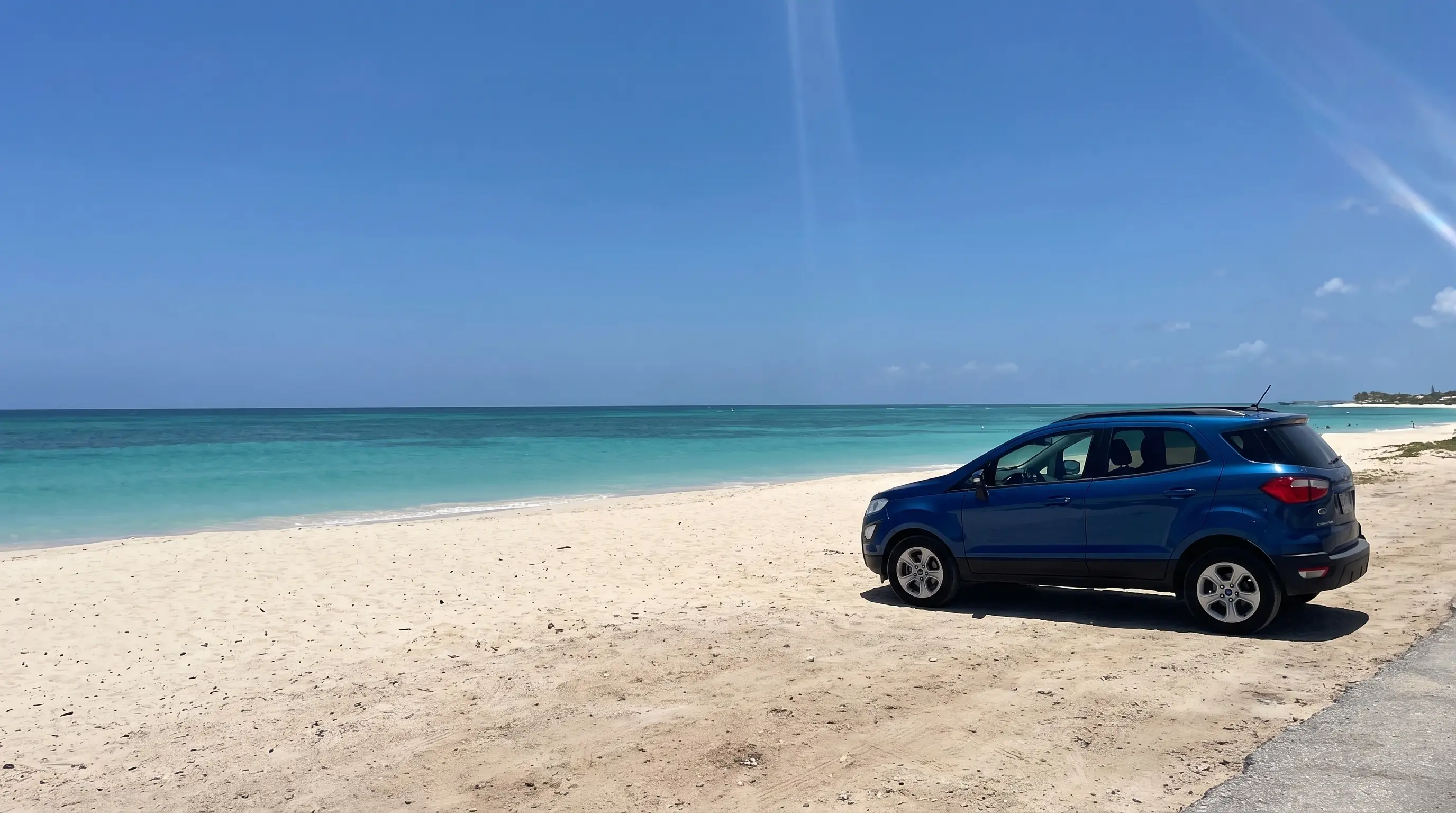 Compact SUV parked near the sand at Palm Beach, Aruba