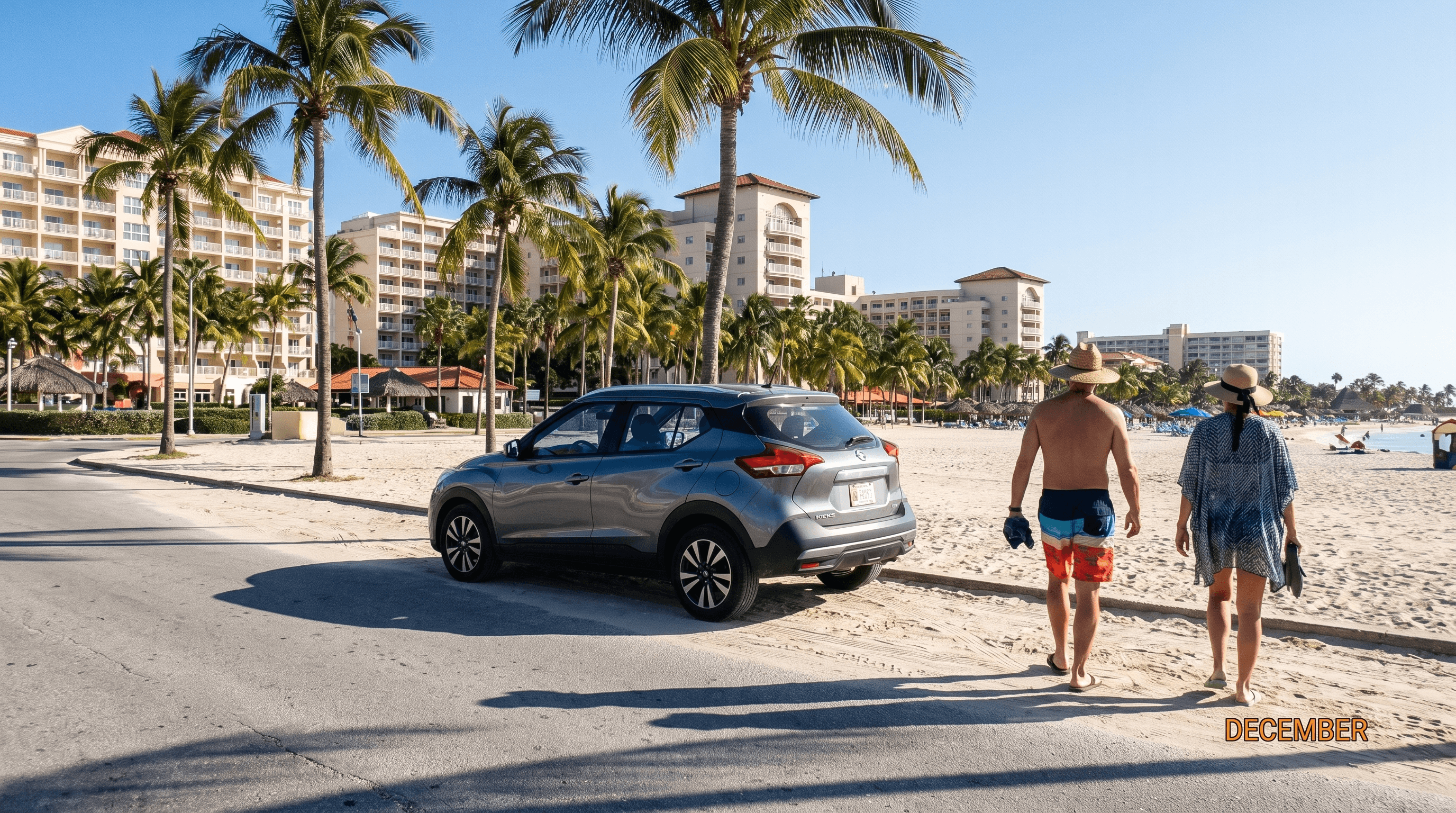 Coastal road at Palm Beach, Aruba, with high-rise hotels, palm trees and a parked rental car